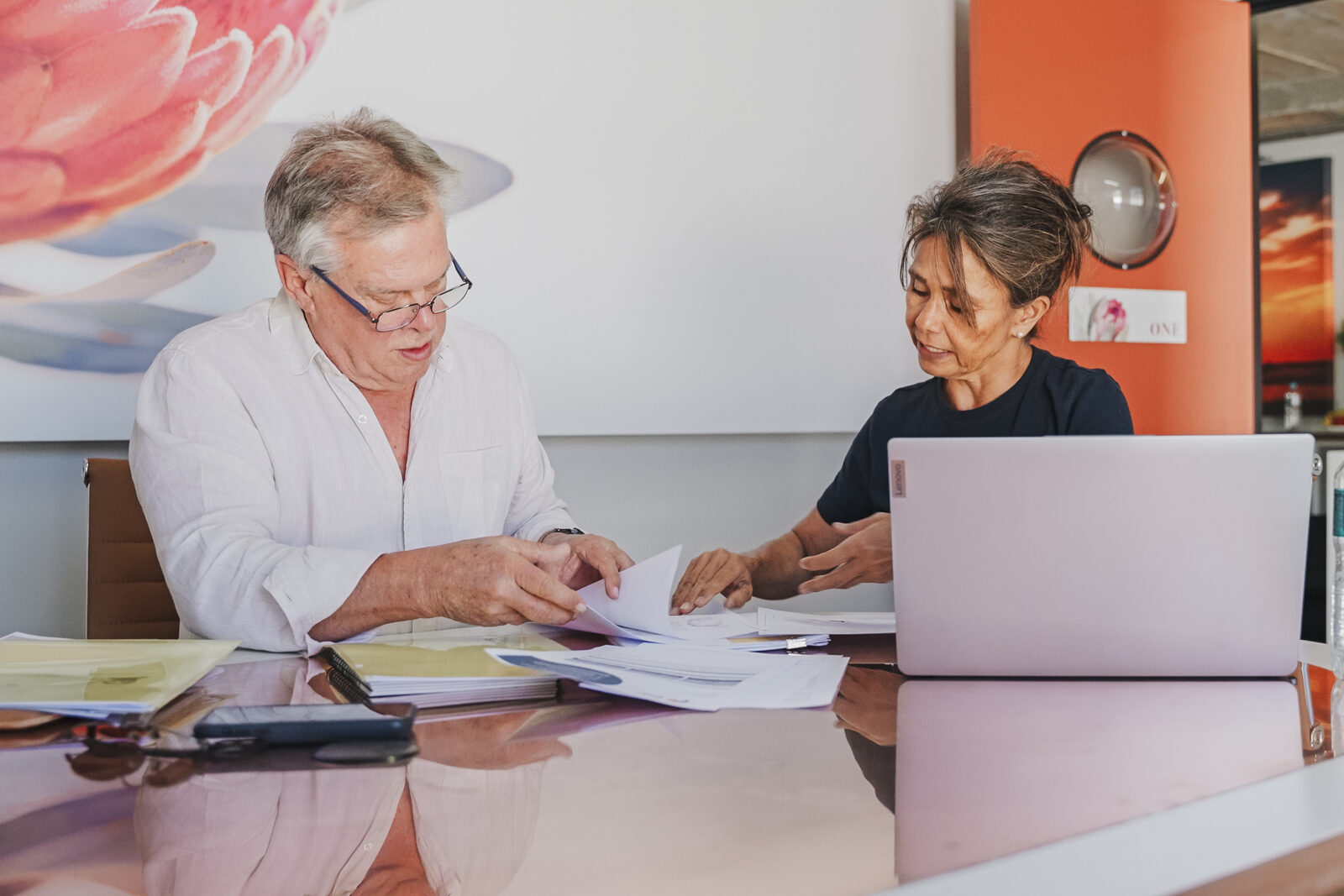Advisor reviewing client documents during a visa assessment.