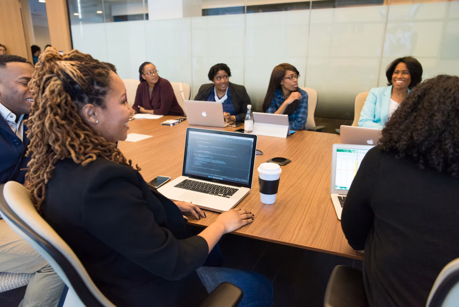 A diverse group of professionals working together in a conference room, the team setting Australia's state-nominated Subclass 190 visa supports.